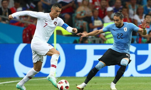Cristiano Ronaldo taking on a defender in Uruguay 2-1 Portugal