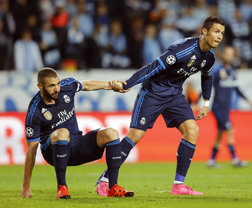 Cristiano Ronaldo helps Karim Benzema to stand up