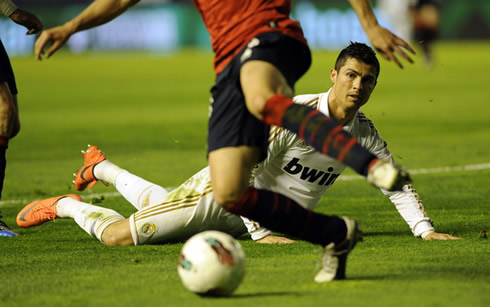 Cristiano Ronaldo goes down but keeps a close eye at the ball