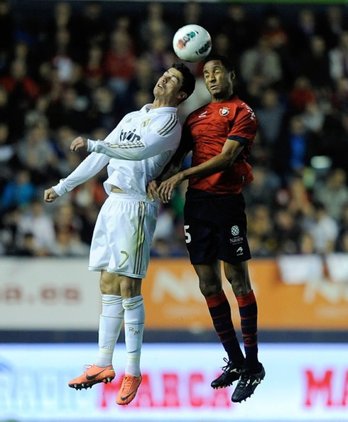 Cristiano Ronaldo jumping and heading the ball in the air