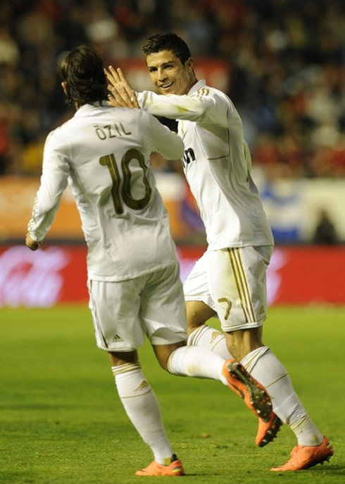 Cristiano Ronaldo touching hands with Mesut Ozil, in Real Madrid 2012