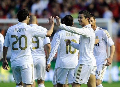 Cristiano Ronaldo touching hands with Gonzalo Higuaín in Real Madrid goal celebrations in 2012
