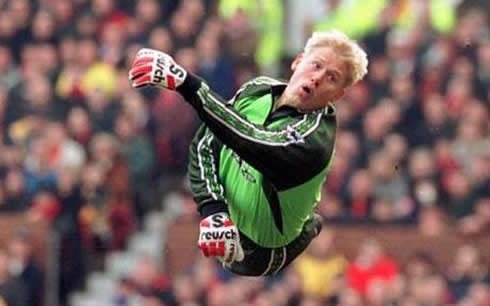Peter Schmeichel in the air, just about to make a great stop and save