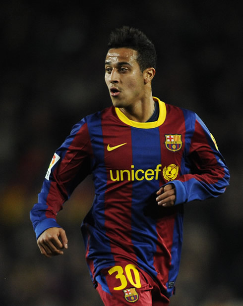 Thiago Alcântara, in a Barcelona's number 30 jersey, with his hair pulled up in the air