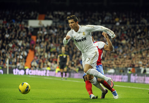 Cristiano Ronaldo dribbling an opponent from Granada and entering the area, while playing for Real Madrid in 2011/12