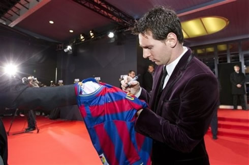 Lionel Messi signing a Barcelona jersey at FIFA's Balon d'Or 2011-2012 gala and ceremony