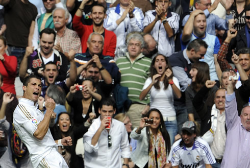 Cristiano Ronaldo celebrating a Real Madrid goal, close to the fans, in the Santiago Bernabéu