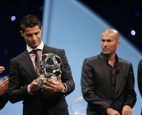 Cristiano Ronaldo receiving the UEFA Champions League award, with Zinedine Zidane behind him