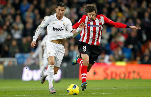 Cristiano Ronaldo running and being pulled, in a Real Madrid game against Athletic Bilbao, in 2011-2012