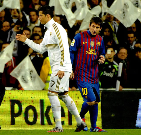 Cristiano Ronaldo saluting Barça players, while Lionel Messi stands by, during the teams entrance in Real Madrid vs Barcelona, in 2011-2012