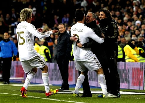 Cristiano Ronaldo hugging José Mourinho, with Fábio Coentrão and Rui Faria near them, during goal celebrations for Real Madrid, in 2012