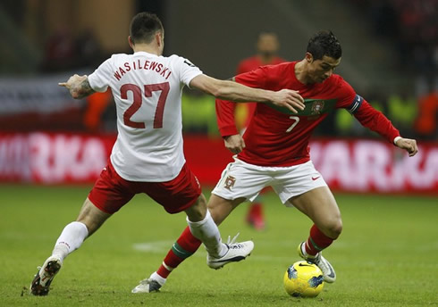 Cristiano Ronaldo dribbling a defender in a friendly match between Poland and Portugal, in 2012