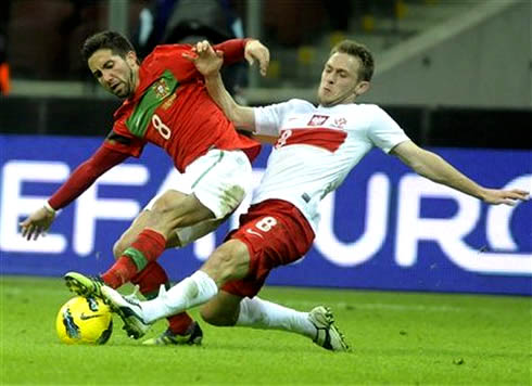 João Moutinho being taclked in Poland vs Portugal, in 2012