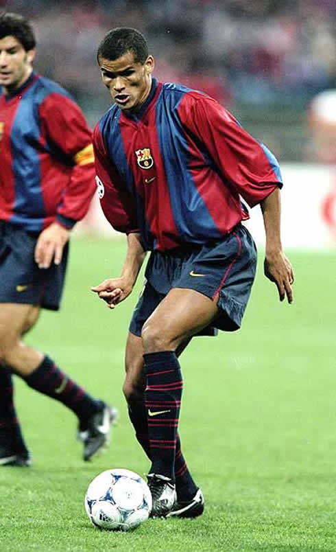 Rivaldo playing for Barcelona, with Luis Figo watching and staring behind him