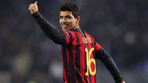 Sergio Kun Aguero playing for Manchester City, in a red and black jersey in 2011-2012