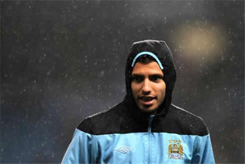 Sergio Kun Aguero training in a rainy day at Manchester City, with a jacket and hood covering his head and hair