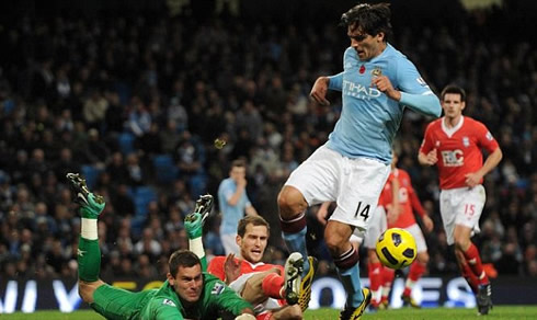 Roque Santa Cruz getting tackled in a match for Manchester City in 2009-2010