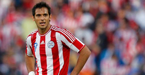 Roque Santa Cruz in a red and white stripe number 9 jersey, playing for Paraguay