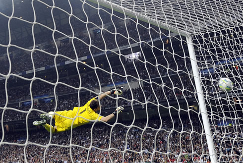 Iker Casillas in Real Madrid, completely in the air throwing himself at a ball