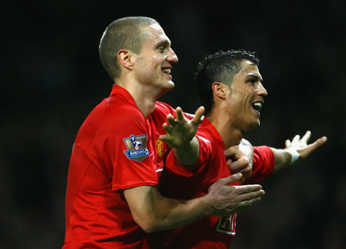 Cristiano Ronaldo being holded by Nemanja Vidic, while celebrating a Manchester United goal