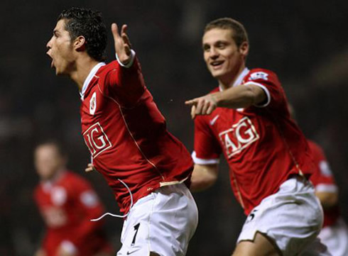 Cristiano Ronaldo chased by Vidic, after scoring a goal for Manchester United in 2009