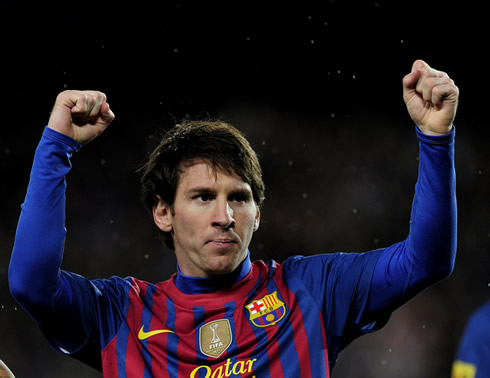 Lionel Messi raising his two hands with close fist, celebrating a new goal scoring record for Barcelona in 2012