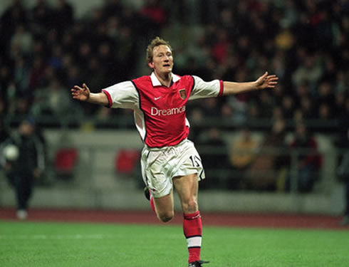 Ray Parlour celebrating a goal for Arsenal, in a classic jersey sponsored by Dreamcast