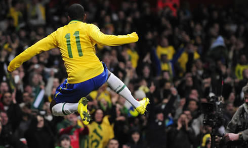 Robinho jumping in the air to celebrate a goal for Brazil, in 2012