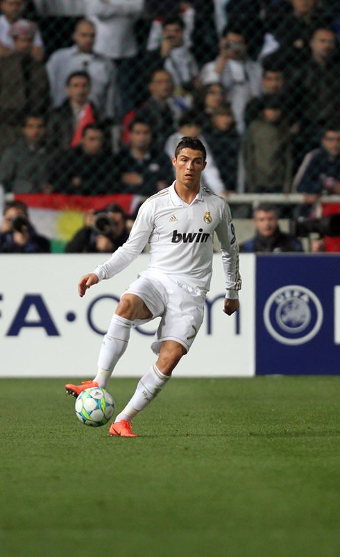 Cristiano Ronaldo making a pass wearing the new red Nike Mercurial Vapor 8 boots and cleats/shoes, in 2012