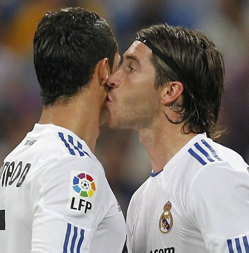 Cristiano Ronaldo being kissed by Sergio Ramos, in Real Madrid.