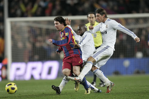 Sergio Ramos tackling hard Barcelona's Lionel Messi from behind while biting his tongue, just before picking a fight