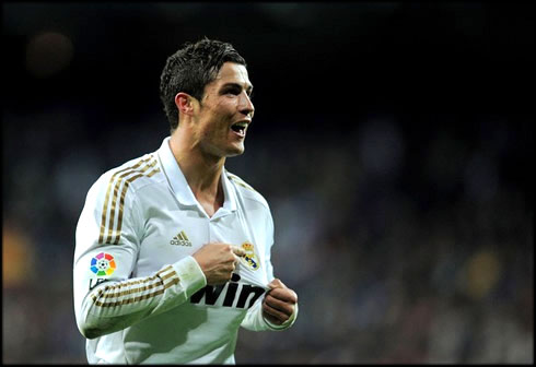 Cristiano Ronaldo goal celebrations, pointing to Real Madrid badge and symbol on his jersey, after scoring the winning goal against Sporting Gijón, in La Liga 2012