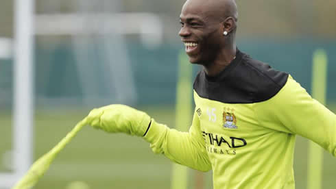 Mario Balotelli being funny, while messing around with a Manchester City training vest or shirt