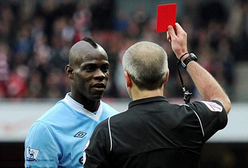 Mario Balotelli being shown the red card when playing for Manchester City vs Arsenal, in 2012