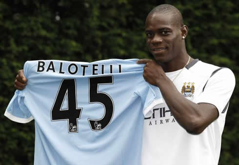 Mario Balotelli holding his Manchester City number 45 jersey