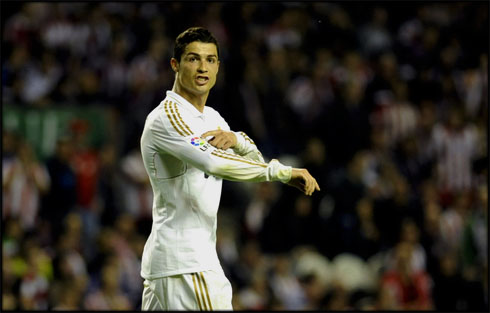 Cristiano Ronaldo pointing to LPF La Liga badge on Real Madrid jersey, to let everyone know that Real Madrid are the champions in 2012
