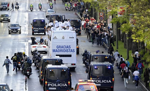 Real Madrid bus guarded by heavy police force, while moving to the Cibeles, in 2012