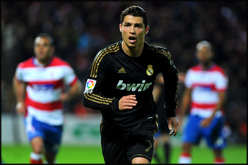 Cristiano Ronaldo playing for Real Madrid, in a black jersey, shirt and uniform, in 2012