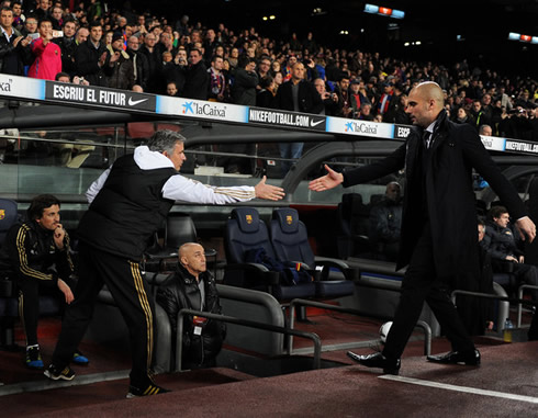 José Mourinho standing up to greet Pep Guardiola, before a match between Real Madrid and Barcelona, in 2012