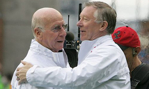 Sir Bobby Charlton hugging Sir Alex Ferguson