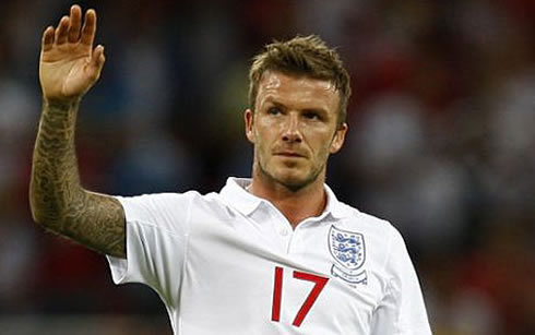 David Beckham raising his tatooed arm, in an England jersey