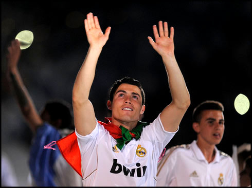 Cristiano Ronaldo thanking Real Madrid fans and supporters, at the Santiago Bernabéu, after winning La Liga and wearing a Portuguese flag on his back, in 2012