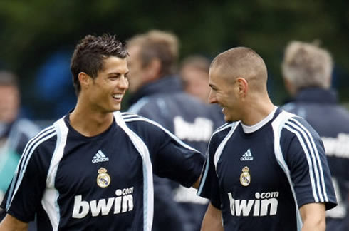 Cristiano Ronaldo and Karim Benzema smiling at a joke, in a Real Madrid training and practice session