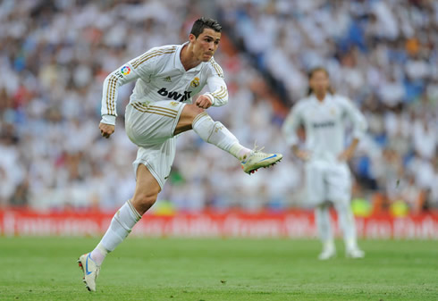 Cristiano Ronaldo showing off his leg strenght, as he shoots a football during a game for Real Madrid in 2012
