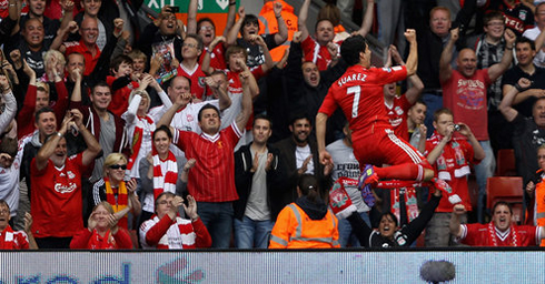 Luis Suárez celebrating a goal for Liverpool, with the Kop fans in the Anfield's crowd