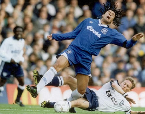 Ruud Gullit being tackled from behind in a game for Chelsea FC