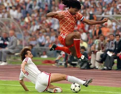 Ruud Gullit jumping over a defender in a game for Holland/Netherlands