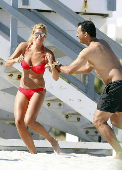 Ruud Gullit shirtless playing around with girlfriend, Estelle Cruijff, on a red sexy bikini