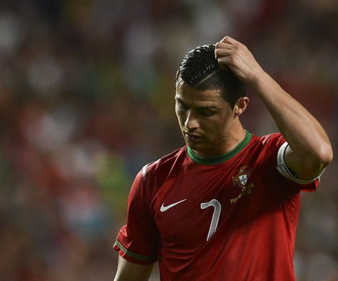 Cristiano Ronaldo scratching his head, thinking about what went wrong in the game between Portugal and Turkey, in 2012