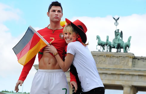 Hot and sexy German girl, hugging a Cristiano Ronaldo statue, with great six pack abs in the EURO 2012